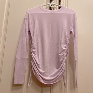 Athleta Beyond Soft top with adjust pull string sides for options. Generous XXS